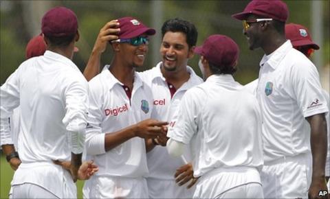 Ravi Rampaul (centre, bare-headed) congratulates Lendl Simmons on a catch