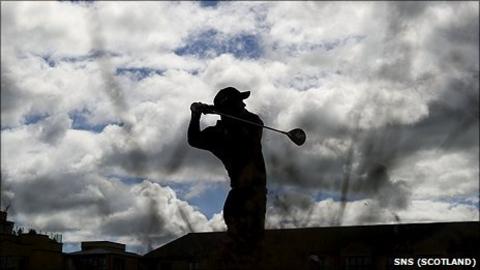 Golfer watches his drive