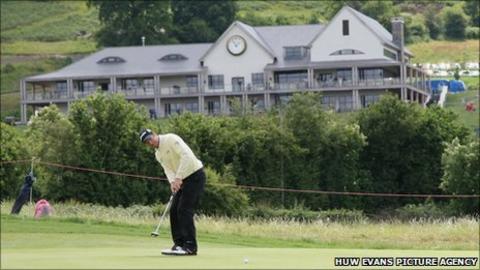 Bradley Dredge makes a putt in the shadow of the Celtic Manor clubhouse