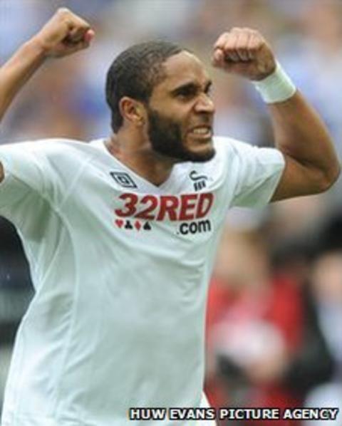 Swansea defender Ashley Williams celebrates their Premier League promotion