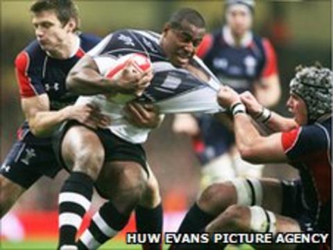 Fiji's Seremaia Bai is tackled by Wales' Danny Lydiate and Dan Biggar