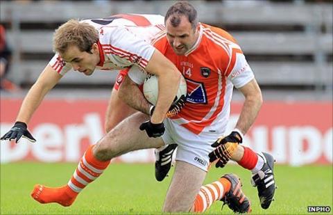 Derry's Brian Og McAlary challenges Armagh skipper Stevie McDonnell