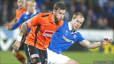 United's David Goodwillie holds off Rangers defender Steven Whittaker