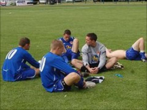 Jersey players on pitch after loss