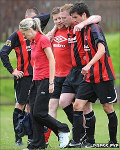 Crusaders player Chris Morrow is helped off during the game against Larne