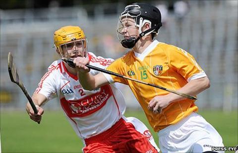 Michael Warnock of Derry in action against Antrim's Daniel McKernan