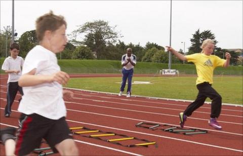 Kriss Akabusi coaches the young athletes