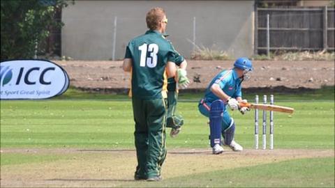 Guernsey cricketer Tim Ravenscroft bowls out an Austrian player