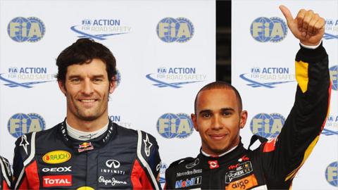 Mark Webber and Lewis Hamilton celebrate after qualifying first and second at the German Grand Prix