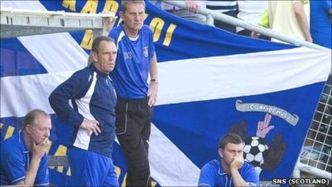 Manager Kenny Shiels surveys the action at Tannadice with his backroom team