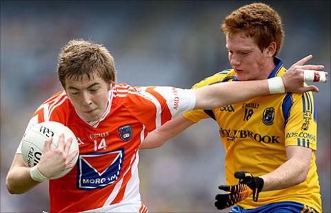 Armagh's Paul McGeown holds off the challenge of Roscommon opponent David O'Dowd