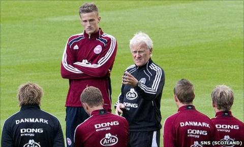 Denmark coach Morten Olsen speaks to his players at training