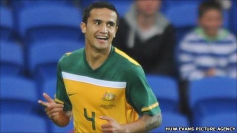 Tim Cahill celebrates scoring Australia's opening goal against Wales