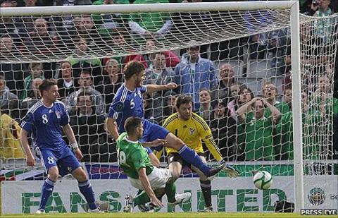 Aaron Hughes sends his shot in off the post to put Northern Ireland into the lead against the Faroe Islands