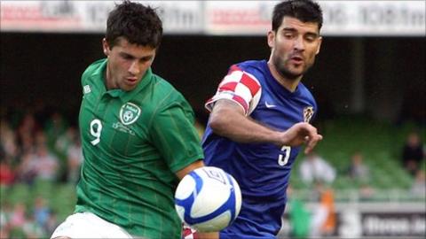 Shane Long and Vedran Corluka battle for possession in the friendly