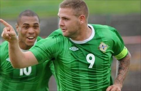 Josh Magennis runs to congratulate hat-trick hero Billy Kee