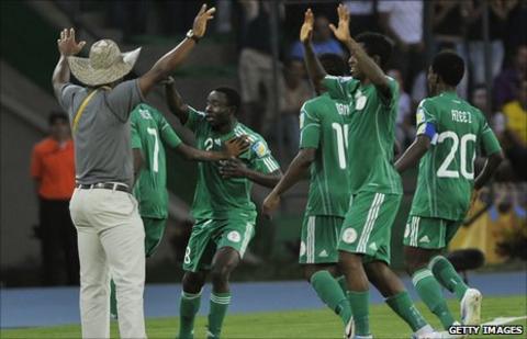 John Obuh (in the hat) celebrates with his team after they take the lead against England
