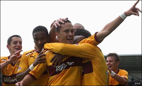 Tom Hateley is mobbed by team-mates after his late winner for Motherwell
