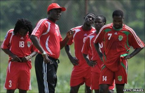 Malawi coach Kinnah Phiri (wearing cap)