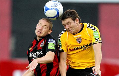 Glenn Cronin of Bohemians goes up for a high ball with Derry City's Kevin Deery