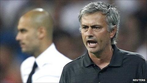 Jose Mourinho (right) with Barca boss Pep Guardiola (background, left)