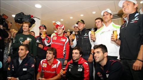Michael Schumacher (centre) and his fellow F1 drivers celebrate his 20 years in the sport