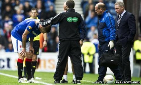 Rangers defender Dorin Goian receives treatment at the side of the pitch