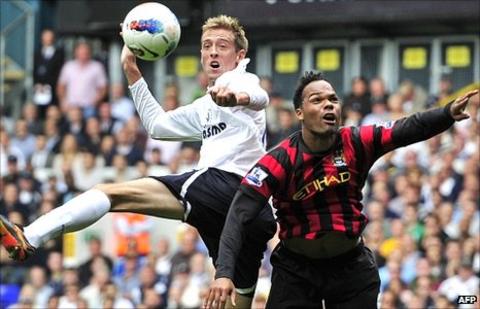Peter Crouch (left) challenges Joleon Lescott