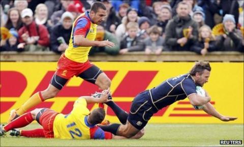 Scotland's Simon Danielli (right) scores a try as Romania's Madalin Lemnaru and Ionut Dimofte fail to tackle him