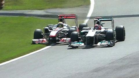 Michael Schumacher forces Lewis Hamilton on to the grass