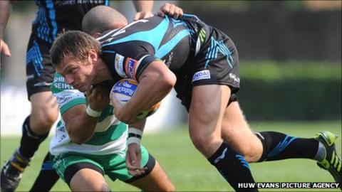 Ospreys fly-half Dan Biggar is tackled by Alberto Chillon of Treviso