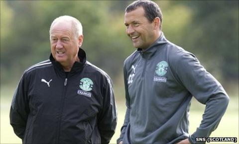 Billy Brown (left) observes training with Hibs manager Colin Calderwood