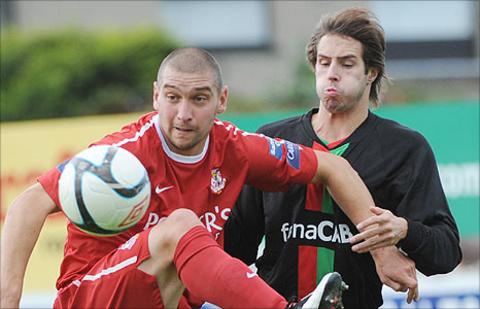 Portadown's Matthew Tipton in action against Sean Ward of Glentoran