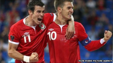 Gareth Bale and Aaron Ramsey celebrate against Montenegro
