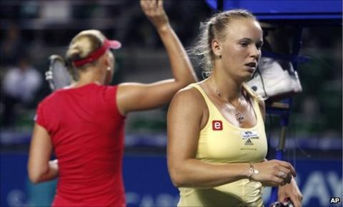 Caroline Wozniacki heads back to her chair after being beaten by Kaia Kanepi