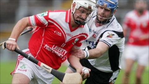 Loughiel's Declan laverty gets a tug from Kevin Lynch's opponent Liam og Hinphey