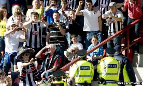 Dunfermline supporters and Fife Police take pictures of each other
