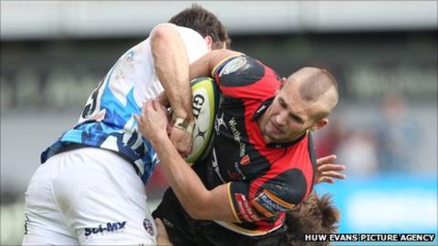 Dragons' Martyn Thomas is tackled by Matt Carraro and Tom Heathcote