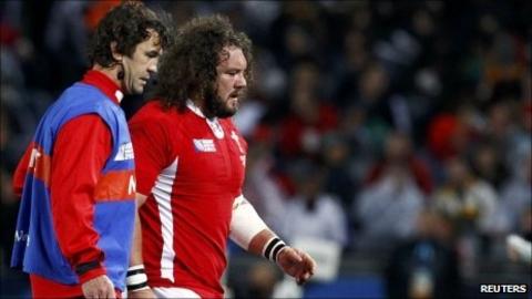 Injured prop Adam Jones leaves the field during the World Cup semi-final