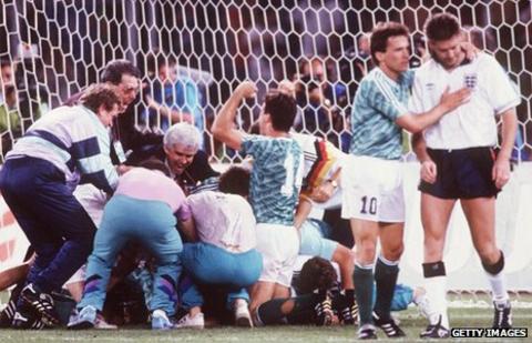 Chris Waddle is consoled after missing a penalty at the 1990 World Cup