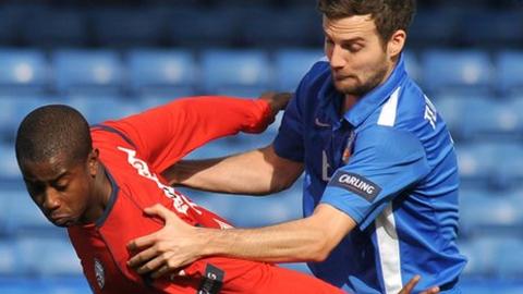 Leon Knight is challenged by Glenavon's Mark Turkington on Saturday