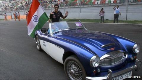 Webber waves an Indian flag during the driver parade at the Buddh International Circuit