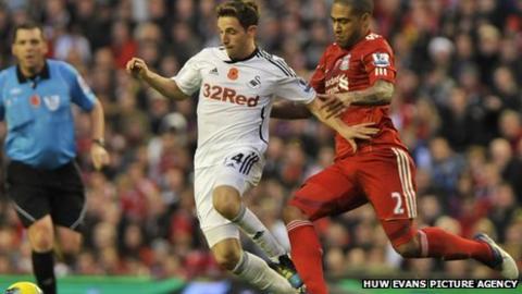 Glen Johnson challenges with Joe Allen