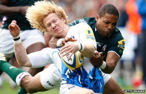 Tom Biggs (left) is tackled by Delon Armitage