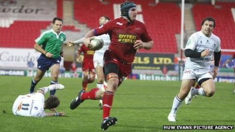 Scarlets back-row Ben Morgan breaks through the Castres defence to score