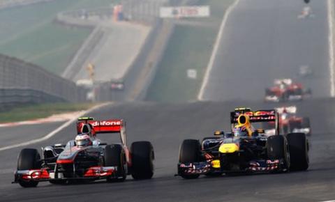 McLaren's Jenson Button tackles Red Bull's Mark Webber in Abu Dhabi