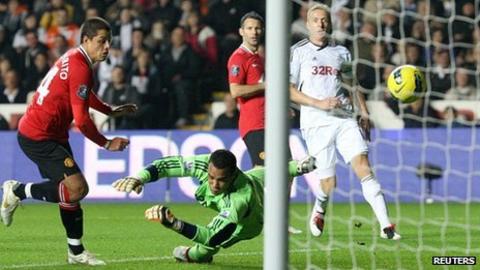 Garry Monk looks on as Javier Hernandez scores the winning goal for Manchester United