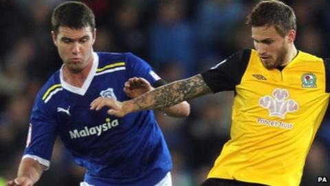 Cardiff's Anthony Gerrard (left) challenges Blackburn's David Goodwillie during their Carling Cup quarter-final