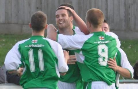 Ross Allen is congratulated by his Guernsey FC teammates