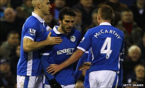 Jordi Gomez celebrates his winner with Wigan team-mates